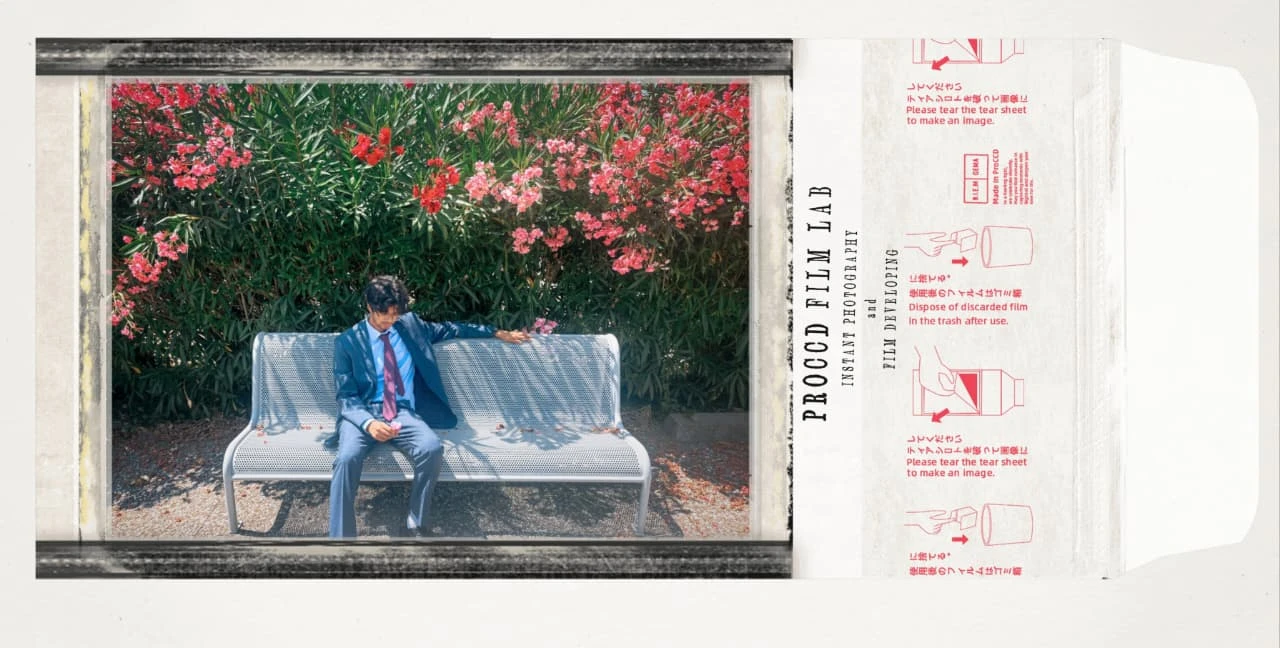 The complete instant-film print, with Himanshu sitting on a silver bench beneath pink flowers and the printed film sleeve alongside